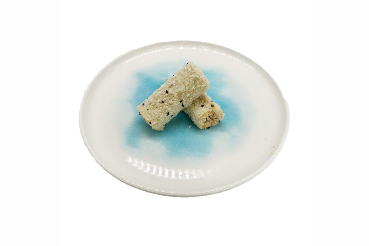 Two double layer milk roll on a round ceramic plate with a blue design on a white background