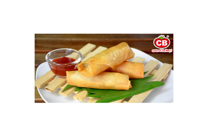Spring rolls on a plate with dipping sauce, branded 'CB'.