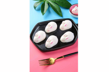 Muuse yogurts on a black tray with a pink background and gold fork.