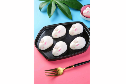 Muuse yogurts on a black tray with a pink background and gold fork.