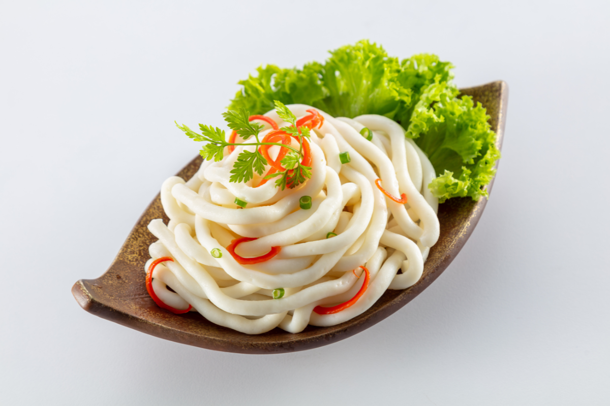 Udon noodles with vegetables on a leaf-shaped plate