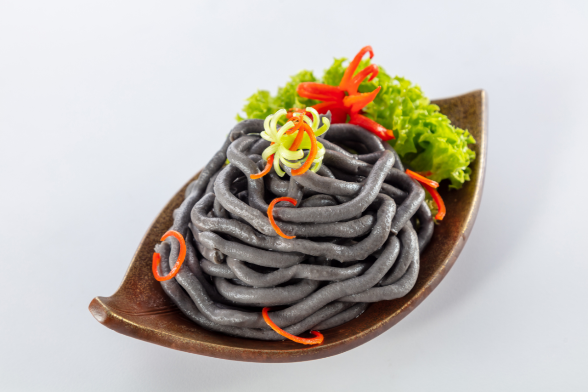 Noodles with garnishes on a white background