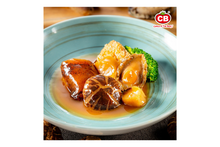 Delicious dish of mixed seafood with a light sauce on a blue plate, featuring the brand 'CB'.
