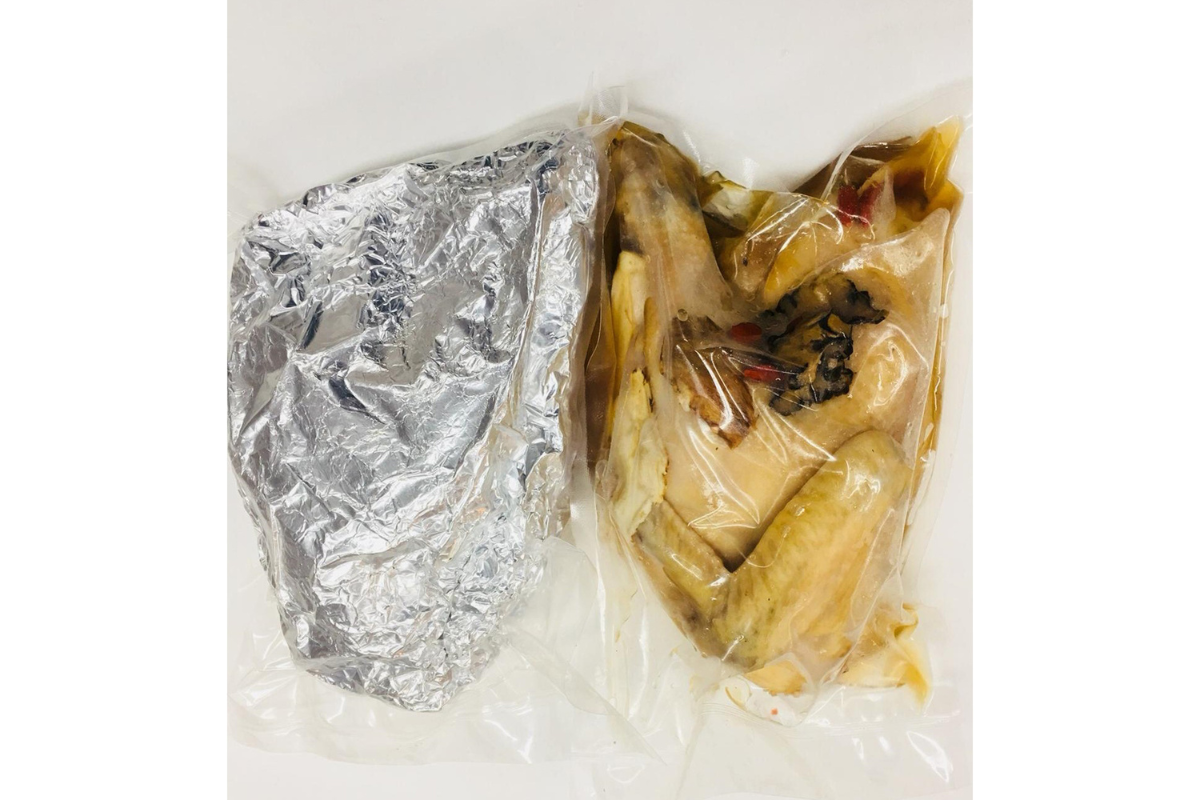 Two packages on a white background, one wrapped in tinfoil and the other in plastic.